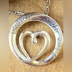 Sterling “Mother is another word for love” 3/4” heart pendant on an 18” chain.